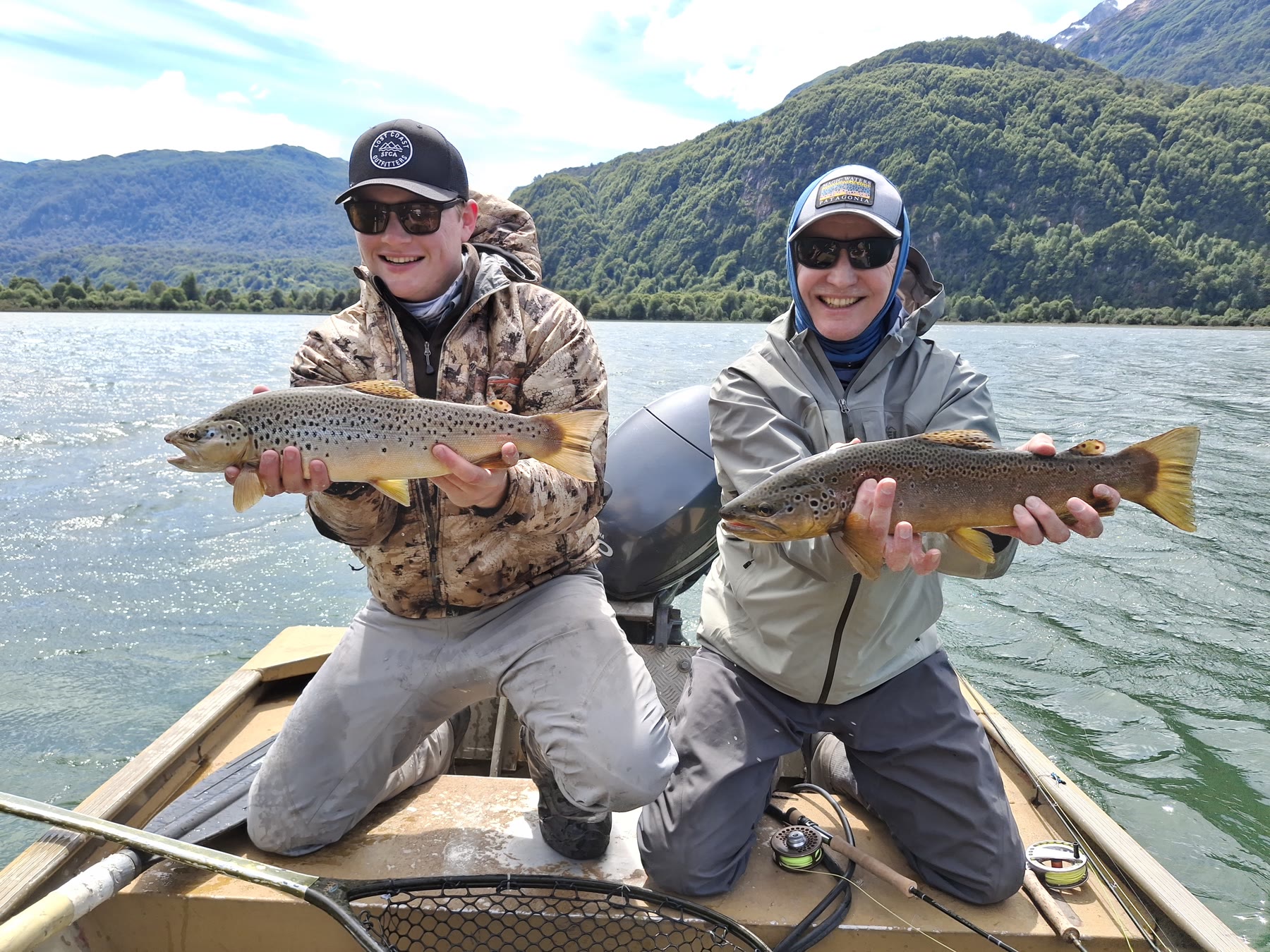 Two anglers with brown trout in a boat on a Chile fly fishing trip