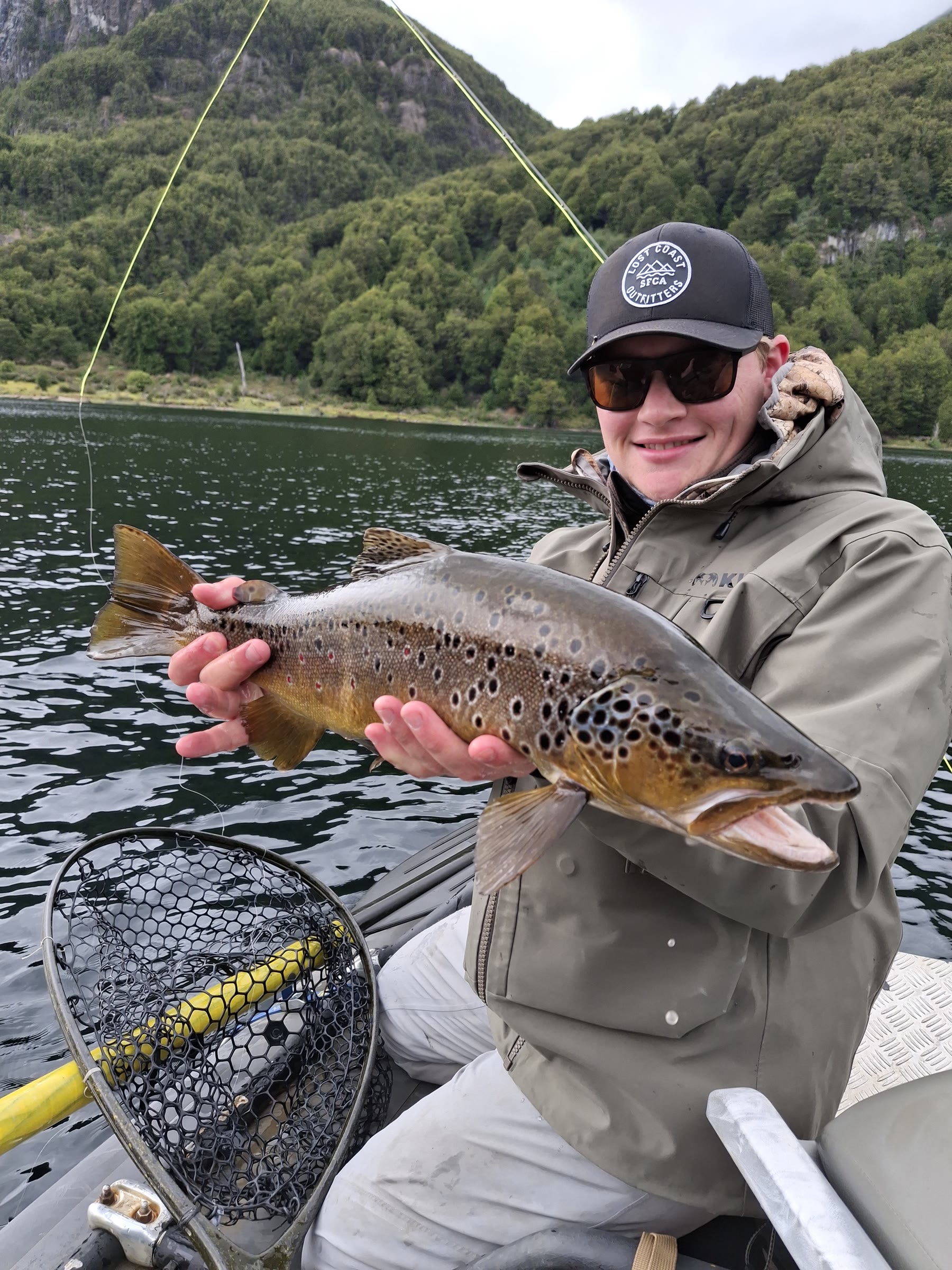 Young angler with a heavy spotted brown trout in Chilean Patagonia