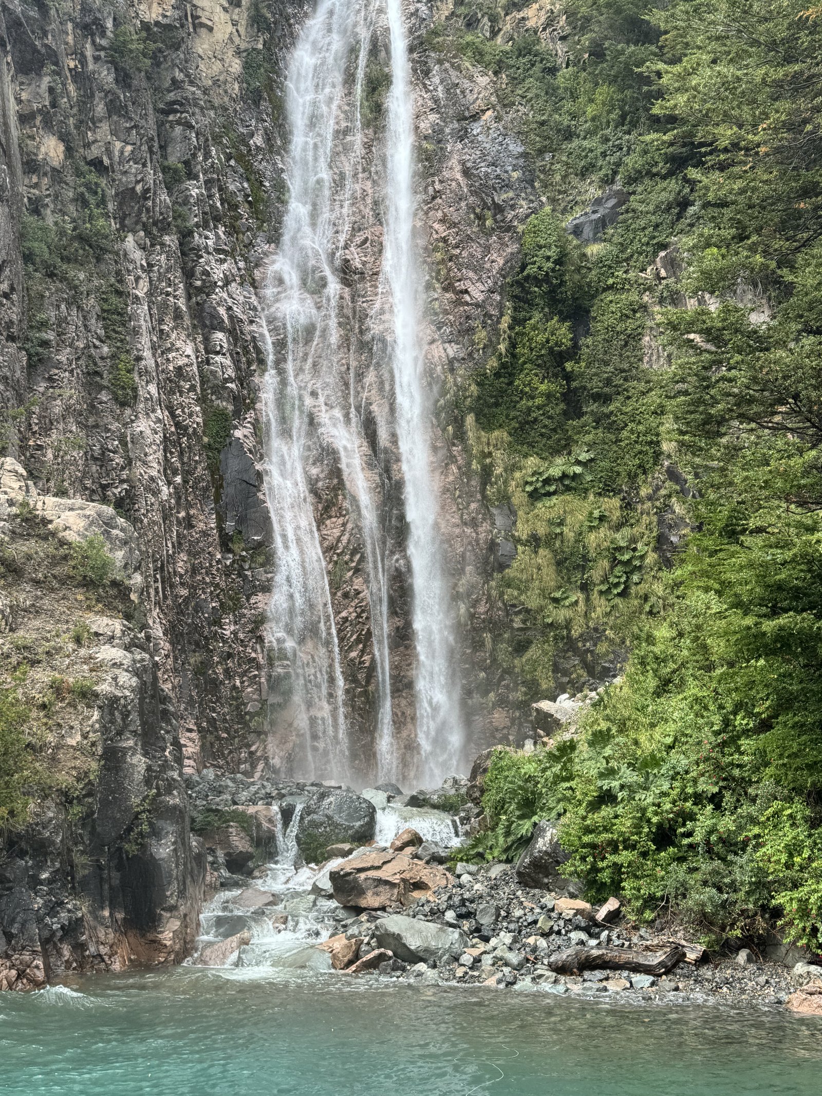 Waterfall into turquoise water in the Aysén region of Chilean Patagonia