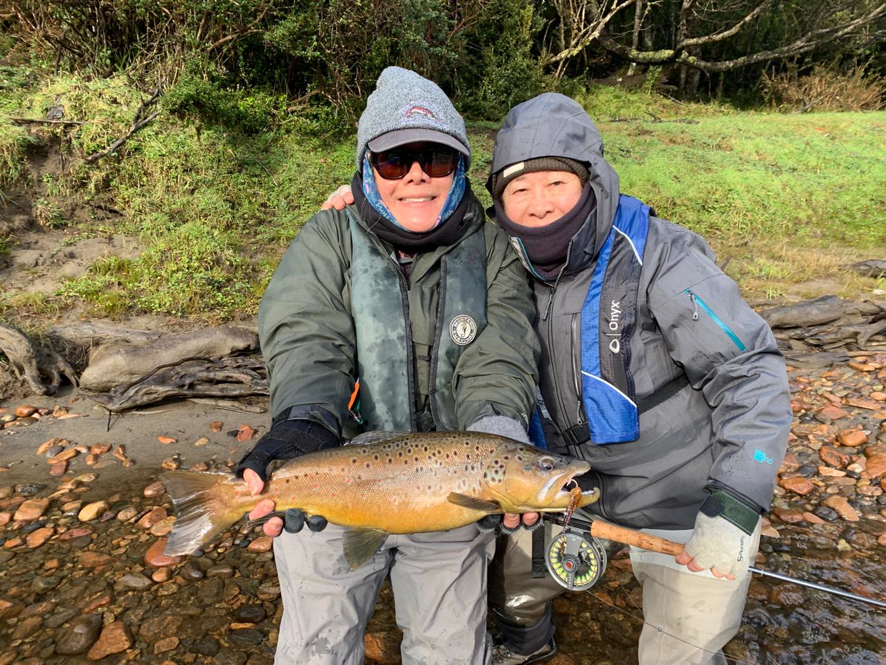 Women anglers with a brown trout on a guided Chile fly fishing trip